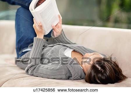 Brunette woman relaxing and reading View Large Photo Image Stock Photograph - Brunette woman relaxing and reading. Fotosearch