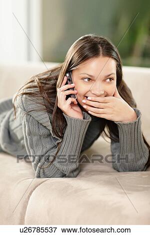 Stock Photo - Brunette woman talking on phone. Fotosearch