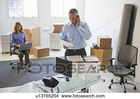Business entrepreneurs working in startup office View Large Photo Image Picture - Business entrepreneurs working in startup office. Fotosearch