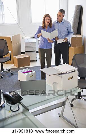 Business entrepreneurs working in startup office View Large Photo Image Stock Photo - Business entrepreneurs working in startup office. Fotosearch