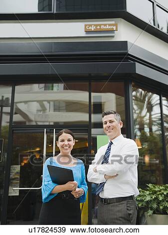 Business owners standing in front of building View Large Photo Image Stock Photo - Business owners standing in front of building. Fotosearch