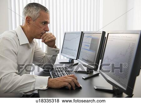 Businessman working at computer View Large Photo Image Stock Photo - Businessman working at computer. Fotosearch