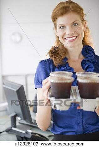 Businesswoman holding a tray of coffee View Large Photo Image Stock Photo - Businesswoman holding a tray of coffee. Fotosearch