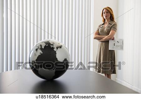 Businesswoman looking at globe View Large Photo Image Picture - Businesswoman looking at globe. Fotosearch