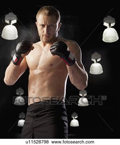 Stock Photo - Cage fighter wearing boxing gloves. Fotosearch
