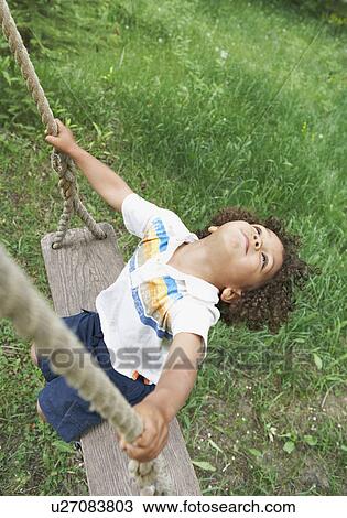 Stock Image - Carefree child swinging. Fotosearch