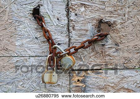 Stock Photography - Chain and padlocks on old door. Fotosearch