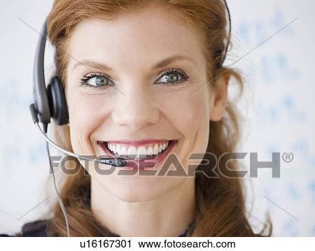 Cheerful businesswoman wearing headset View Large Photo Image Stock Image - Cheerful businesswoman wearing headset. Fotosearch