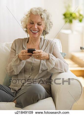 Stock Photo - Cheerful woman texting. Fotosearch