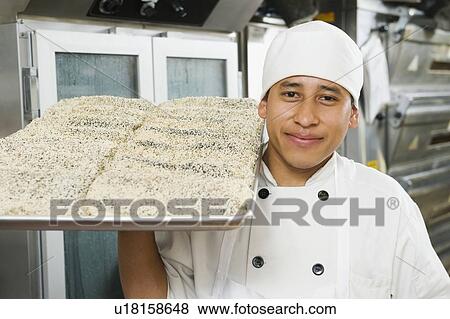 Chef holding tray of bread View Large Photo Image Stock Photo - Chef holding tray of bread. Fotosearch