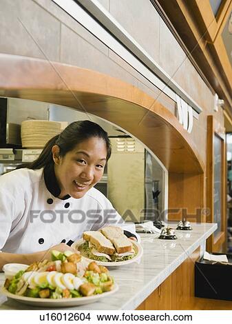 Picture - Chef leaning on counter. Fotosearch