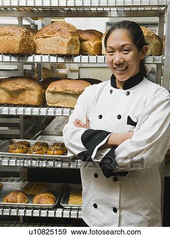 Chef standing beside trays of freshly baked goods View Large Photo Image Stock Photo - Chef standing beside trays of freshly baked goods. Fotosearch