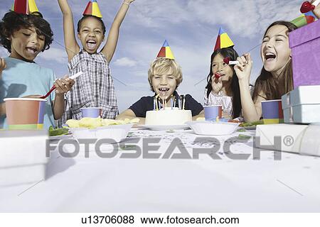 Stock Photo - Children at a birthday celebration. Fotosearch