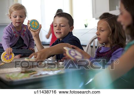 Stock Photograph - Children baking cookies. Fotosearch