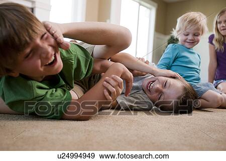 Children play fighting on floor View Large Photo Image Stock Photo - Children play fighting on floor. Fotosearch