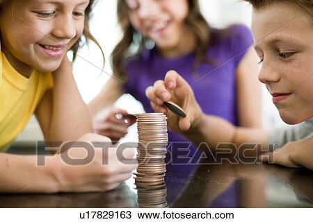 Children stacking coins View Large Photo Image Stock Image - Children stacking coins. Fotosearch