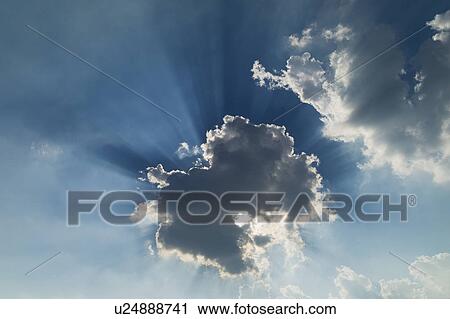 Stock Image - Clouds and light beam. Fotosearch