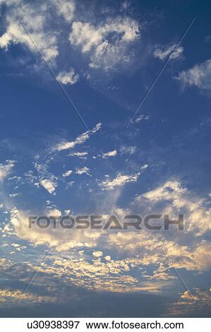 Clouds in blue sky at dusk View Large Photo Image Stock Photo - Clouds in blue sky at dusk. Fotosearch