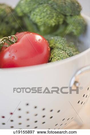 Colander of broccoli and tomatoes View Large Photo Image Stock Photo - Colander of broccoli and tomatoes. Fotosearch