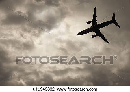 Commercial jet in cloudy sky View Large Photo Image Stock Image - Commercial jet in cloudy sky. Fotosearch