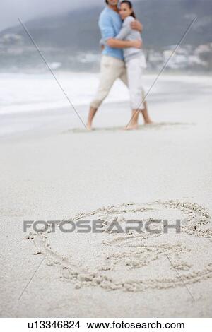 Couple embracing at the beach View Large Photo Image Picture - Couple embracing at the beach. Fotosearch
