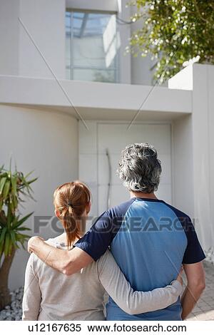 Stock Photography - Couple looking at their home. Fotosearch