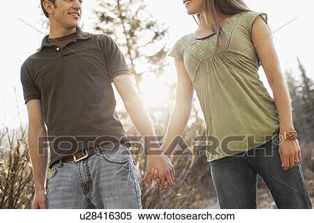 Stock Photography - Couple walking hand in hand. Fotosearch