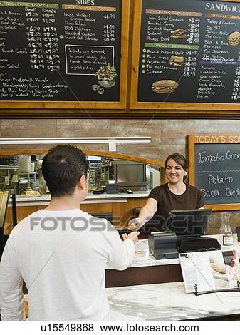 Stock Photo - Customer paying for his bakery order. Fotosearch