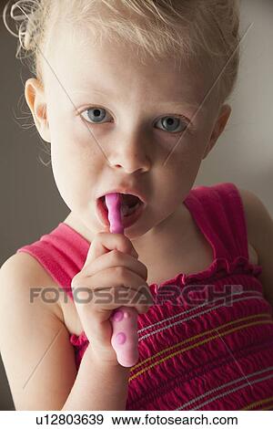 Stock Photo - Cute young girl brushing her teeth. Fotosearch