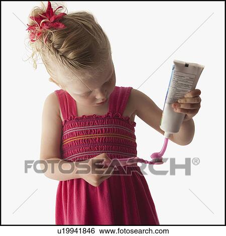 Stock Photograph - Cute young girl brushing her teeth. Fotosearch