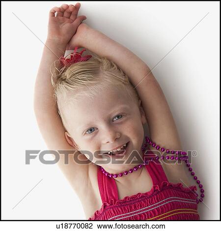 Cute young girl lying down View Large Photo Image Stock Image - Cute young girl lying down. Fotosearch