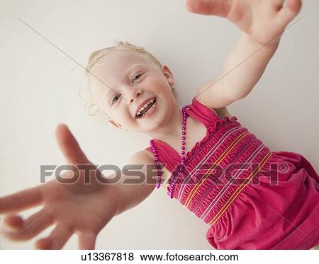 Stock Photo - Cute young girl lying down. Fotosearch