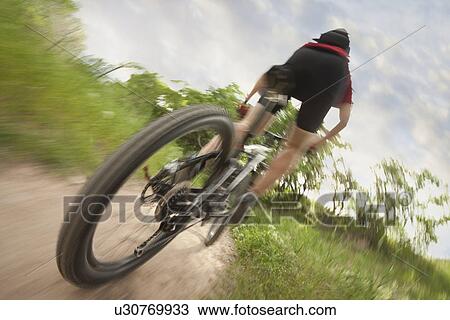 Cyclist on single track trail View Large Photo Image Stock Image - Cyclist on single track trail. Fotosearch