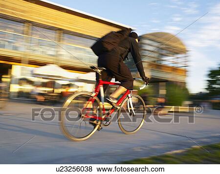 Cyclist riding bike on Vancouver street View Large Photo Image Stock Photo - Cyclist riding bike on Vancouver street. Fotosearch