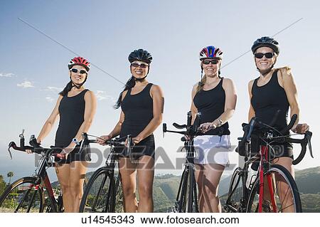 Cyclists standing beside their bikes on the side of the road View Large Photo Image Stock Image - Cyclists standing beside their bikes on the side of the road. Fotosearch