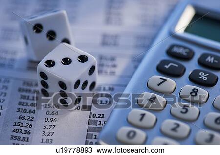 Stock Image - Dice calculator and financial document. Fotosearch