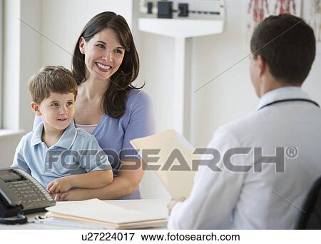 Doctor talking to woman and her son View Large Photo Image Stock Photo - Doctor talking to woman and her son. Fotosearch