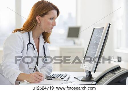 Stock Photo - Doctor working at computer. Fotosearch