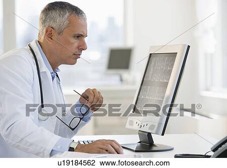 Doctor working on computer View Large Photo Image Stock Image - Doctor working on computer. Fotosearch
