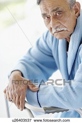 Stock Photo - Elderly patient leaning on a walker. Fotosearch