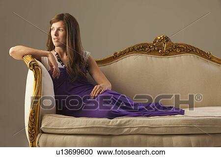 Elegant woman lounging on antique sofa View Large Photo Image Stock Image - Elegant woman lounging on antique sofa. Fotosearch