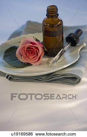 Stock Photograph - Essential oil and rose on tray. Fotosearch