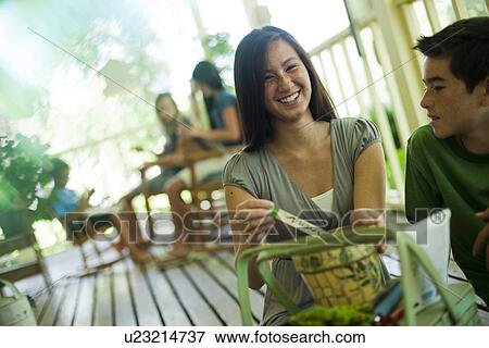 Stock Photo - Family relaxing on porch. Fotosearch