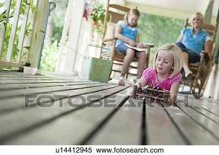 Family relaxing on porch View Large Photo Image Stock Photography - Family relaxing on porch. Fotosearch