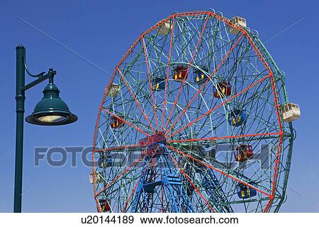 Stock Photo - Ferris wheel and lamppost. Fotosearch