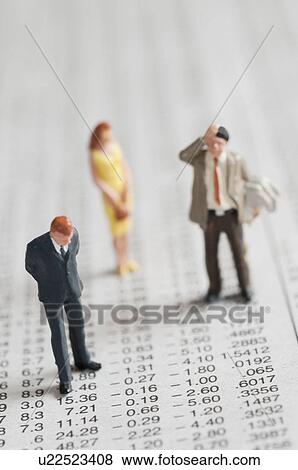 Stock Photo - Figurines of people standing on stock chart. Fotosearch