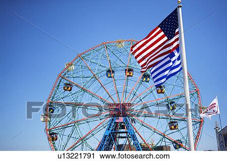 Flags in front of Ferris wheel View Large Photo Image Stock Image - Flags in front of Ferris wheel. Fotosearch