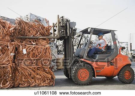 Forklift driver working at recycling plant View Large Photo Image Stock Photo - Forklift driver working at recycling plant. Fotosearch