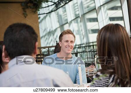 Stock Photo - Friends at outdoor cafe. Fotosearch