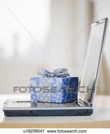 Stock Photo - Gift on laptop. Fotosearch